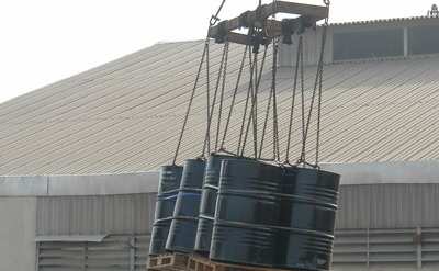 A slung pallet of drums lifted for loading